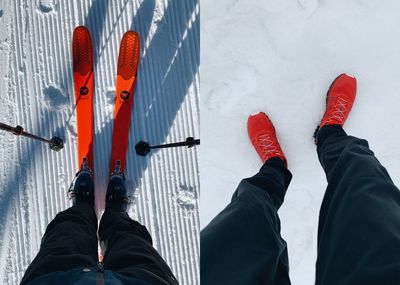 Low section of man standing by red shoes