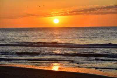 Scenic view of sea against romantic sky at sunset