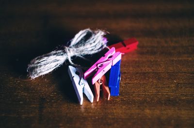 High angle view of clothespins and threads on table