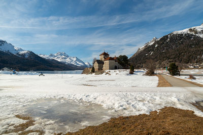 Silvaplana,switzerland, february 21, 2023 historic old castle crap da sass at the lake of silvaplana 
