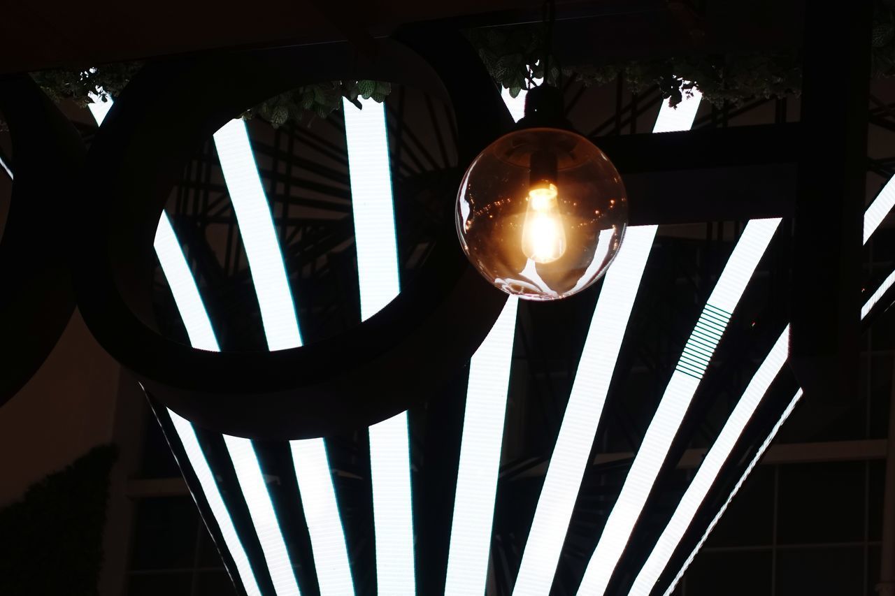 LOW ANGLE VIEW OF ILLUMINATED LIGHT BULBS HANGING FROM CEILING