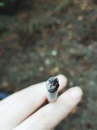 Close-up of woman holding cigarette 