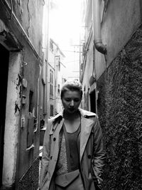 Young woman walking in alley