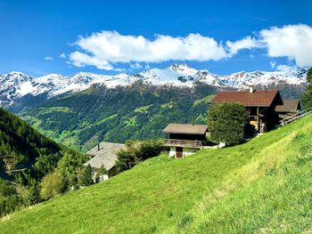 Panoramic view of houses and mountains against sky