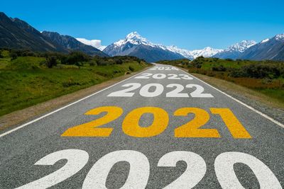 Text on road by mountain against sky