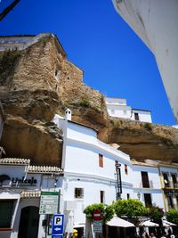 Low angle view of buildings against clear blue sky