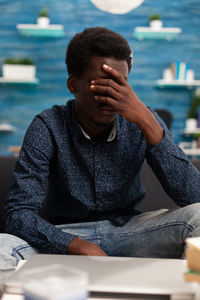 Portrait of a man sitting on table