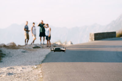 People on mountain road against sky