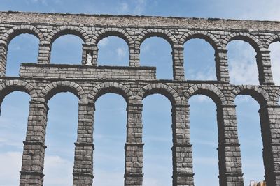 Low angle view of aqueduct against blue sky