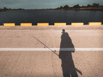 High angle view of person standing by sea