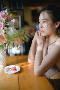 Close-up of young woman drinking coffee at home