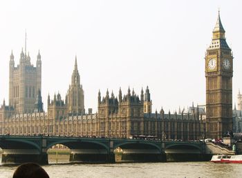 View of buildings and bridge in city against sky