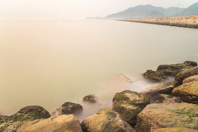 Panoramic view of sea and mountains against sky