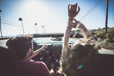 Rear view of couple sitting in car