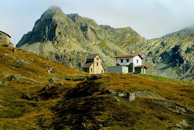 Scenic view of building and mountains against sky