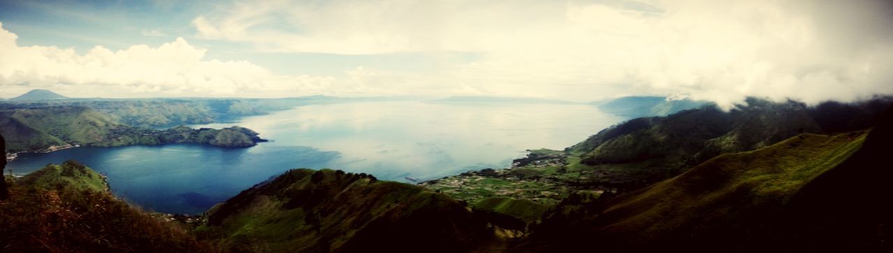 scenics, mountain, tranquil scene, tranquility, beauty in nature, sky, water, nature, cloud - sky, landscape, mountain range, idyllic, rock - object, non-urban scene, geology, rock formation, cloud, cloudy, physical geography, sea