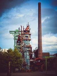 Low angle view of factory against sky