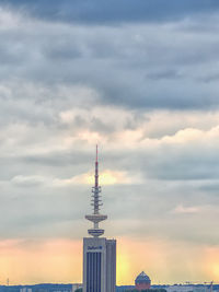 City skyline against cloudy sky