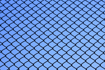 Full frame shot of chainlink fence against sky