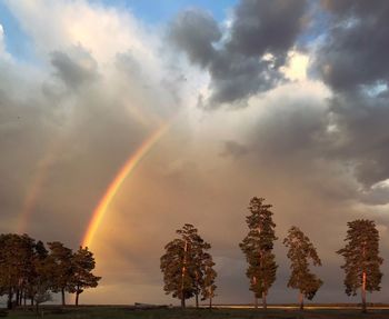Scenic view of rainbow against sky during sunset