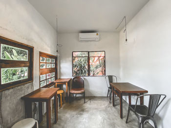 Empty chairs and table against wall at home