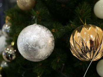 Close-up of decorations hanging on christmas tree