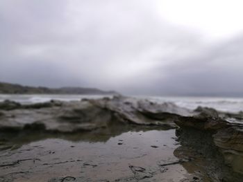 Scenic view of sea against cloudy sky