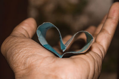 Close-up of hand holding heart shape