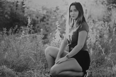 Young woman sitting on field