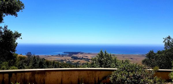 Scenic view of sea against clear blue sky