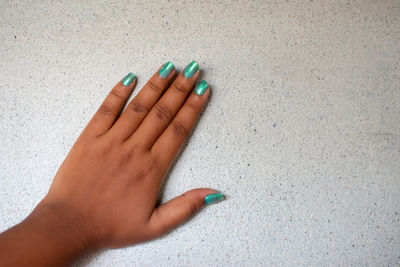 Closeup top view of two beautiful hands of woman with professional manicure, nails painted.