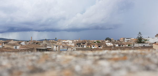 Buildings in town against sky