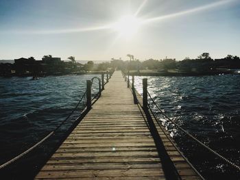 Pier over river against sky