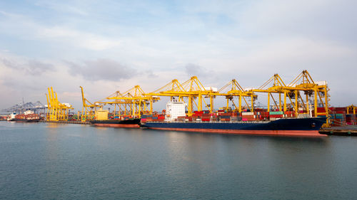 Container ship at industrial port in import export global business services logistic 