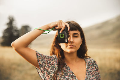 Young woman photographing through camera