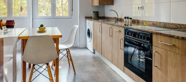 Kitchen interior decorated with furniture and appliances