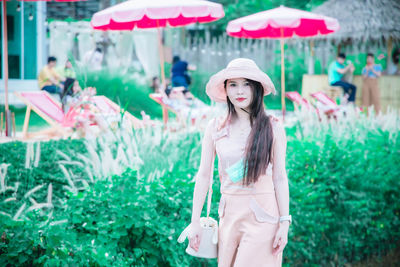 Portrait of young woman standing outdoors