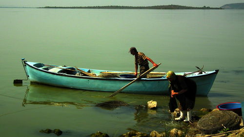 Couple preparing for fishing on shore