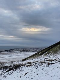 Scenic view of sea against sky during winter