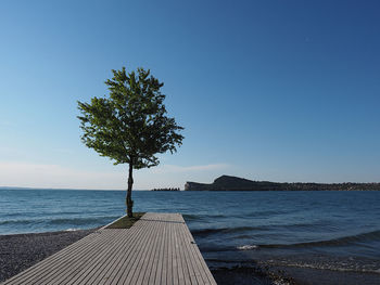 Scenic view of sea against clear blue sky