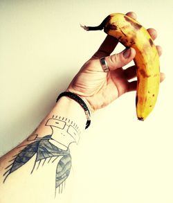 Close-up of hand holding hands over white background