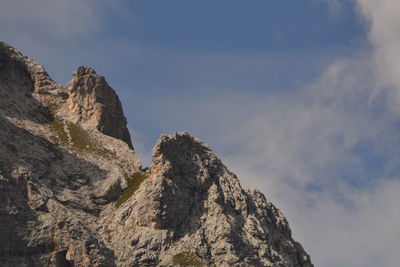 Low angle view of rocky mountains against sky