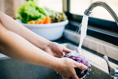 Low section of woman washing hands