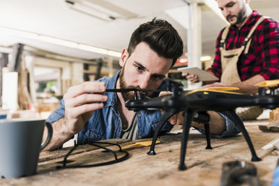 Man working on drone in workshop