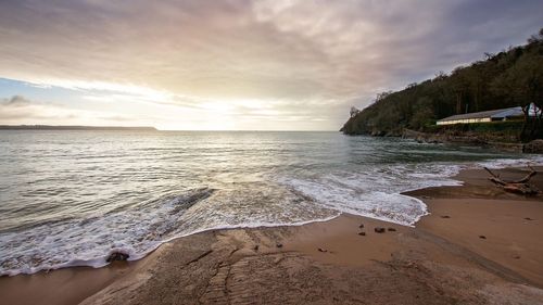 Scenic view of beach against sky during sunset