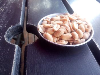 High angle view of salted peanuts in bowl on table