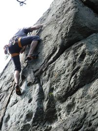 Low section of man on rock at beach