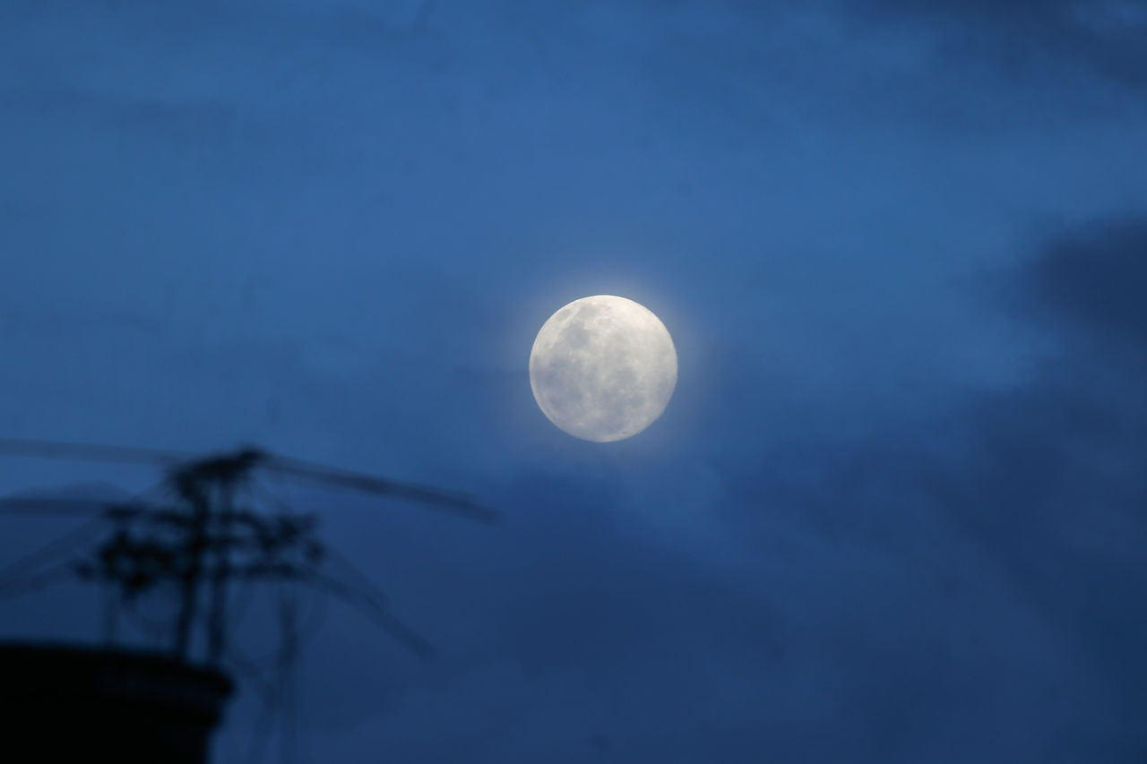 LOW ANGLE VIEW OF MOON IN SKY