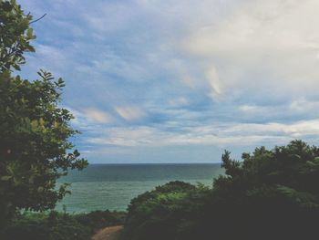 Scenic view of sea against cloudy sky