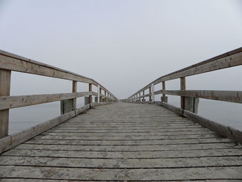 View of footbridge against clear sky